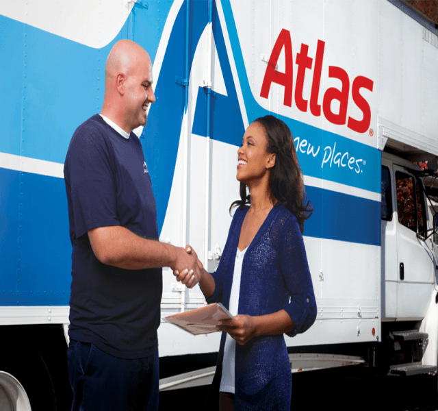 Evergreen Moving team member greeting a customer beside an Atlas truck